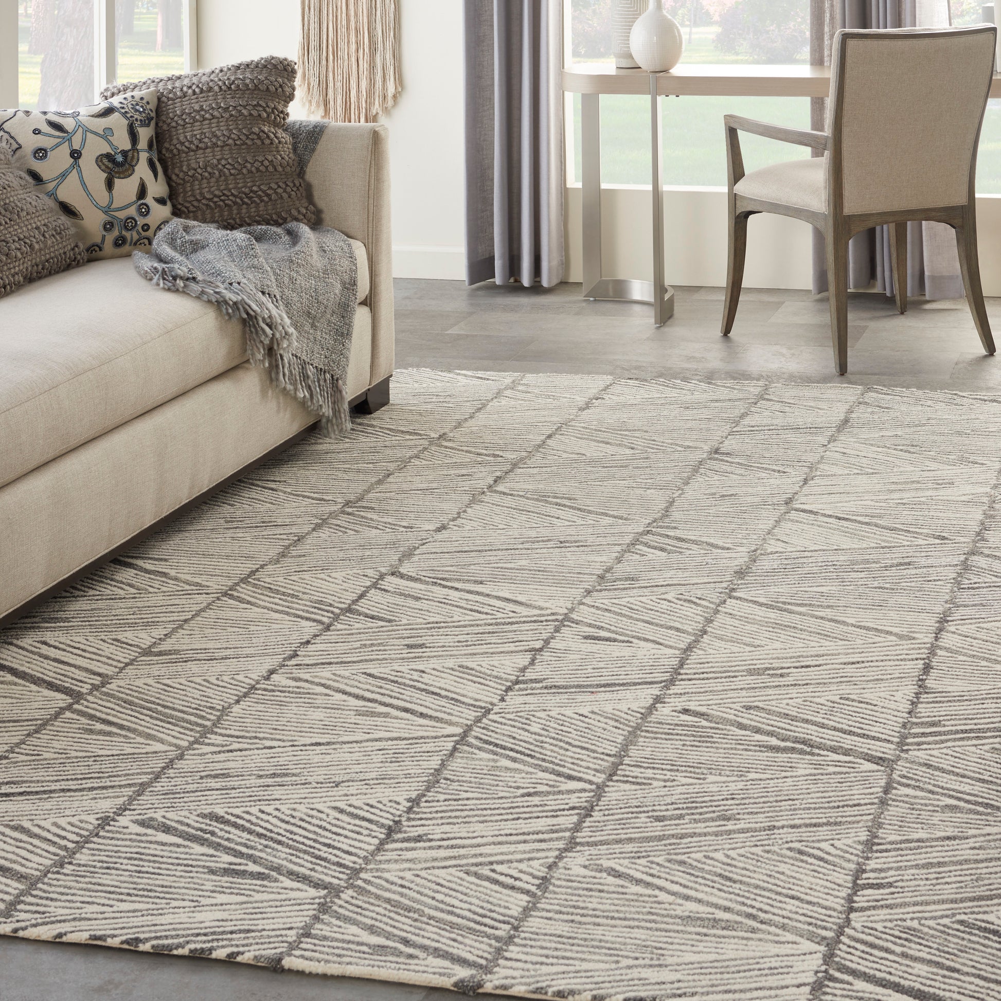 Beige rug with a light woven geometric pattern; size 8' x 12'.