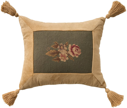 Rectangular gold-tan velvet pillow with a dark green center panel featuring rose embroidery; tassels at each corner.