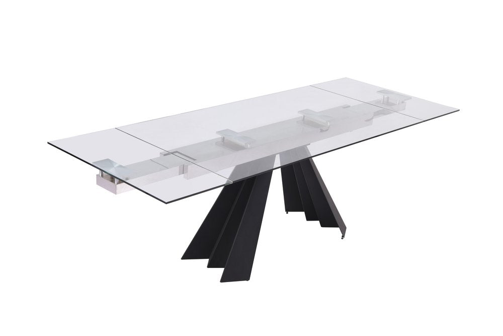 Rectangular clear glass dining table with a sculptural black angular pedestal base, modern contemporary style.