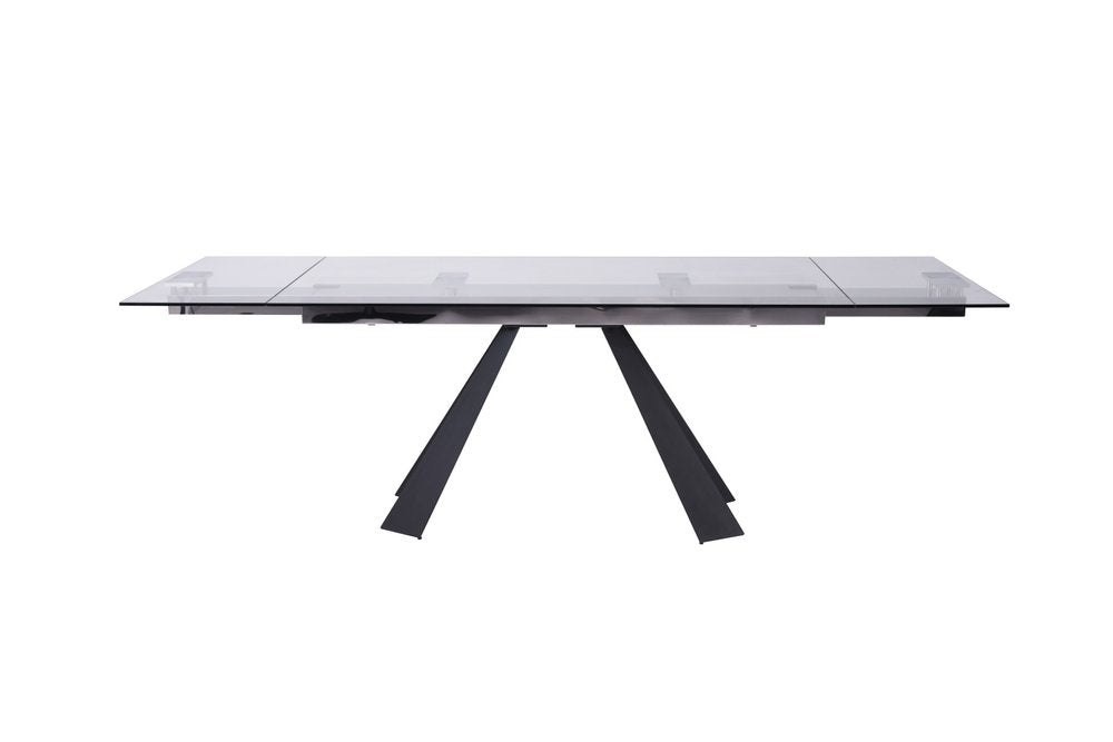 Rectangular clear glass dining table with black angled V-shaped base, modern contemporary design.
