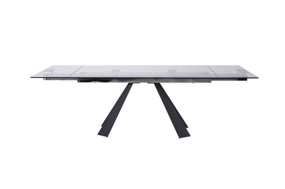 Rectangular clear glass dining table with black angled V-shaped base, modern contemporary design.