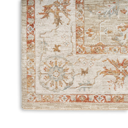 Beige oriental area rug with faded floral medallions, rust-red border and blue accents; distressed vintage look.