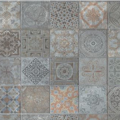 Square ceramic tiles in a vintage patchwork pattern with arabesque and geometric motifs in muted blue gray and beige.