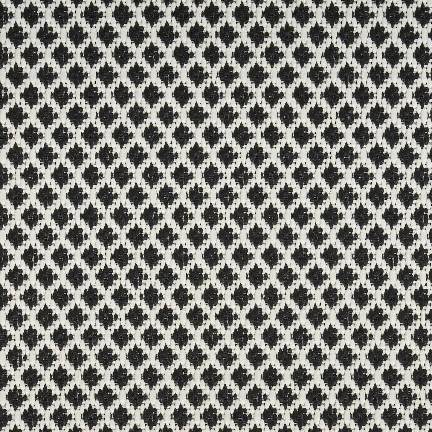 Close-up of a black and white woven rug with a tiny diamond lattice pattern; a 10' runner rug.