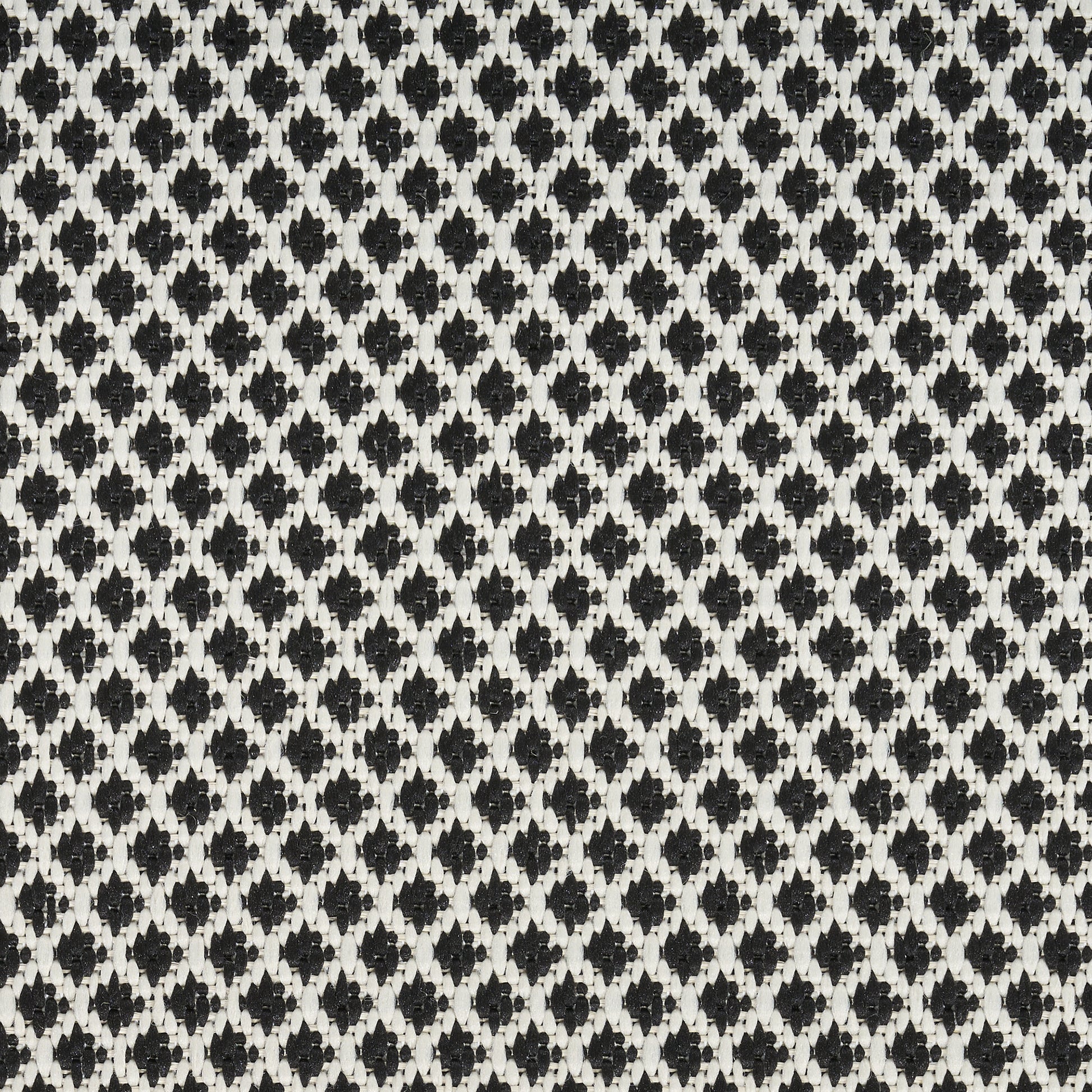 Close-up of a black and white woven rug with a tiny diamond lattice pattern; a 10' runner rug.