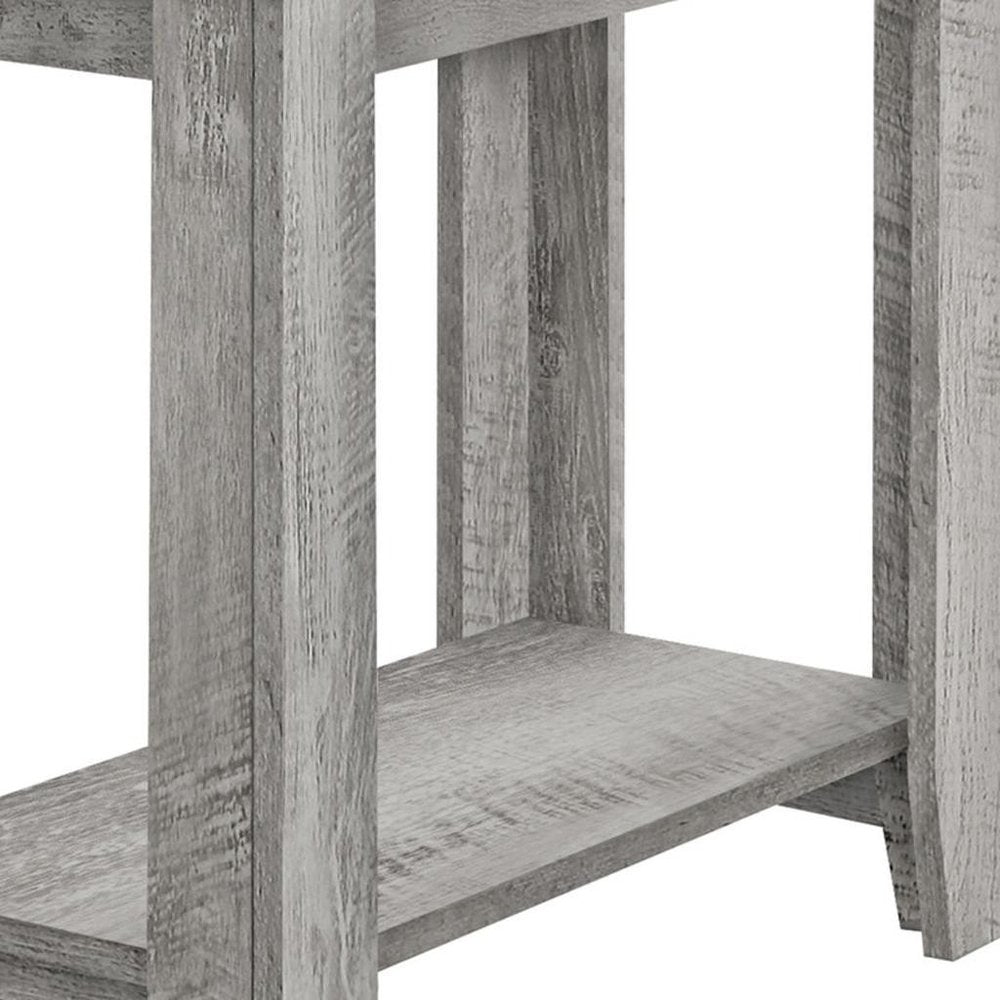 Rustic greywashed wooden table with a lower shelf and visible grain.