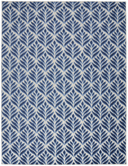Indigo blue leaf-trellis rug with repeating ivory leaves on cream background; rectangular.