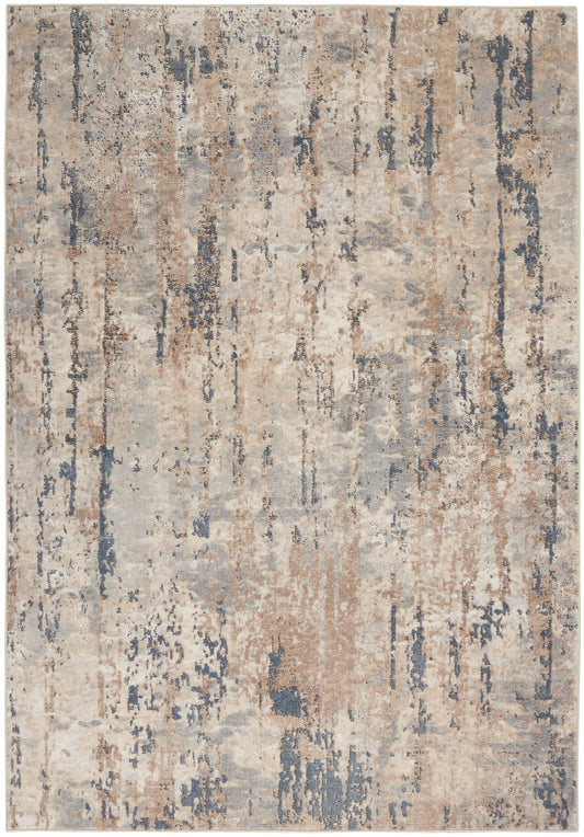 Abstract distressed area rug in beige, tan, gray & blue tones with a soft, mottled pile.