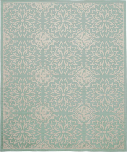 Teal area rug with repeating ivory floral medallions and decorative border.