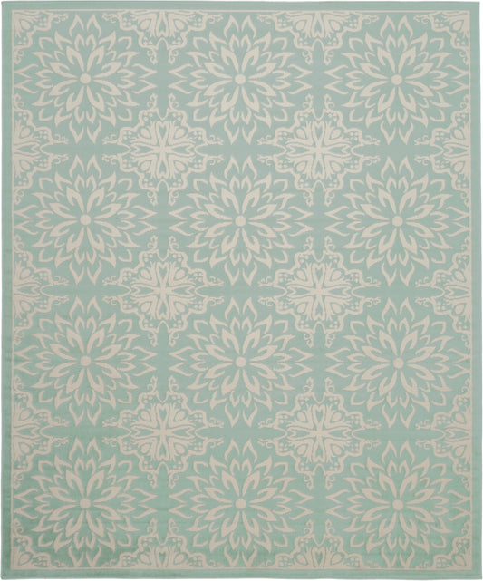 Teal area rug with repeating ivory floral medallions and decorative border.