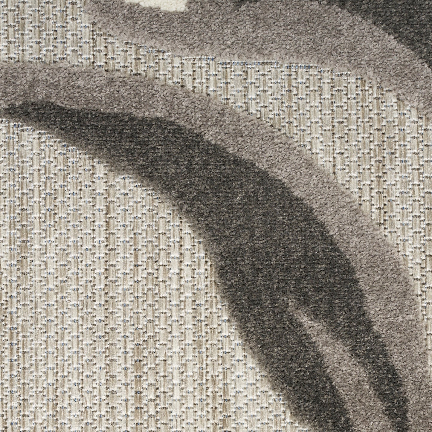Abstract arc-pattern round rug in beige with dark gray curved bands; plush woven pile.