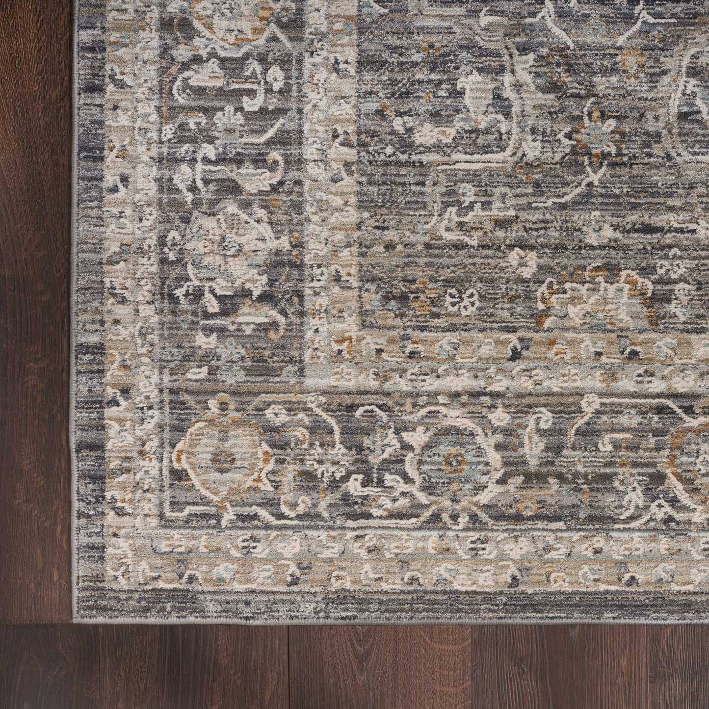 Intricate gray-blue Persian-style runner with ivory & tan scroll motifs, ornate border, 8' long, on dark wood floor.