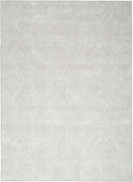 Light grey textured rug with faint circular woven pattern, soft pile, modern floor decor.