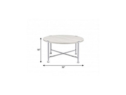 Round coffee table with white and silver metal cross legs, 36in dia, 18in high.