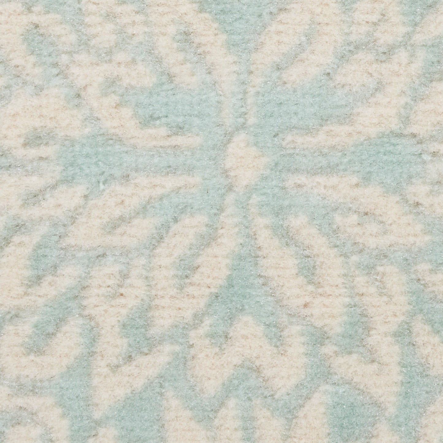 Powder-blue rug with ivory geometric medallion pattern and soft plush pile.