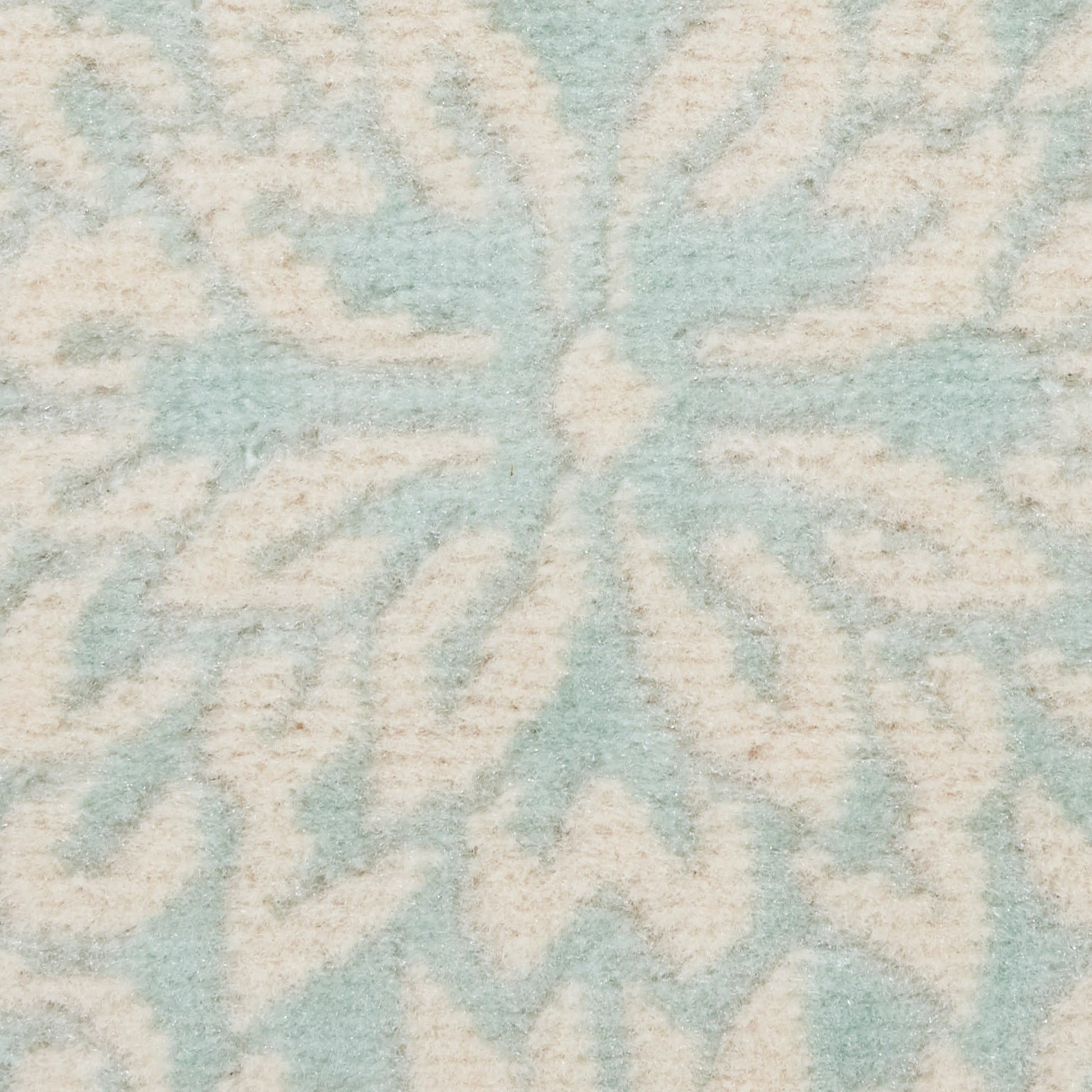Powder-blue rug with ivory geometric medallion pattern and soft plush pile.