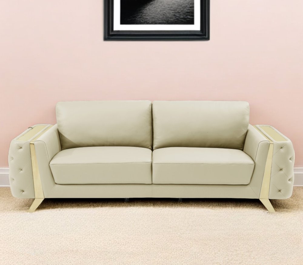 Beige Italian leather sofa with gold legs, 90" long.