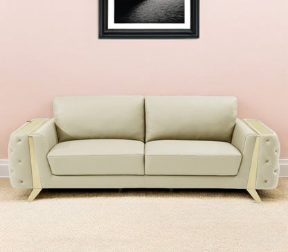 Beige Italian leather sofa with gold legs, 90" long.