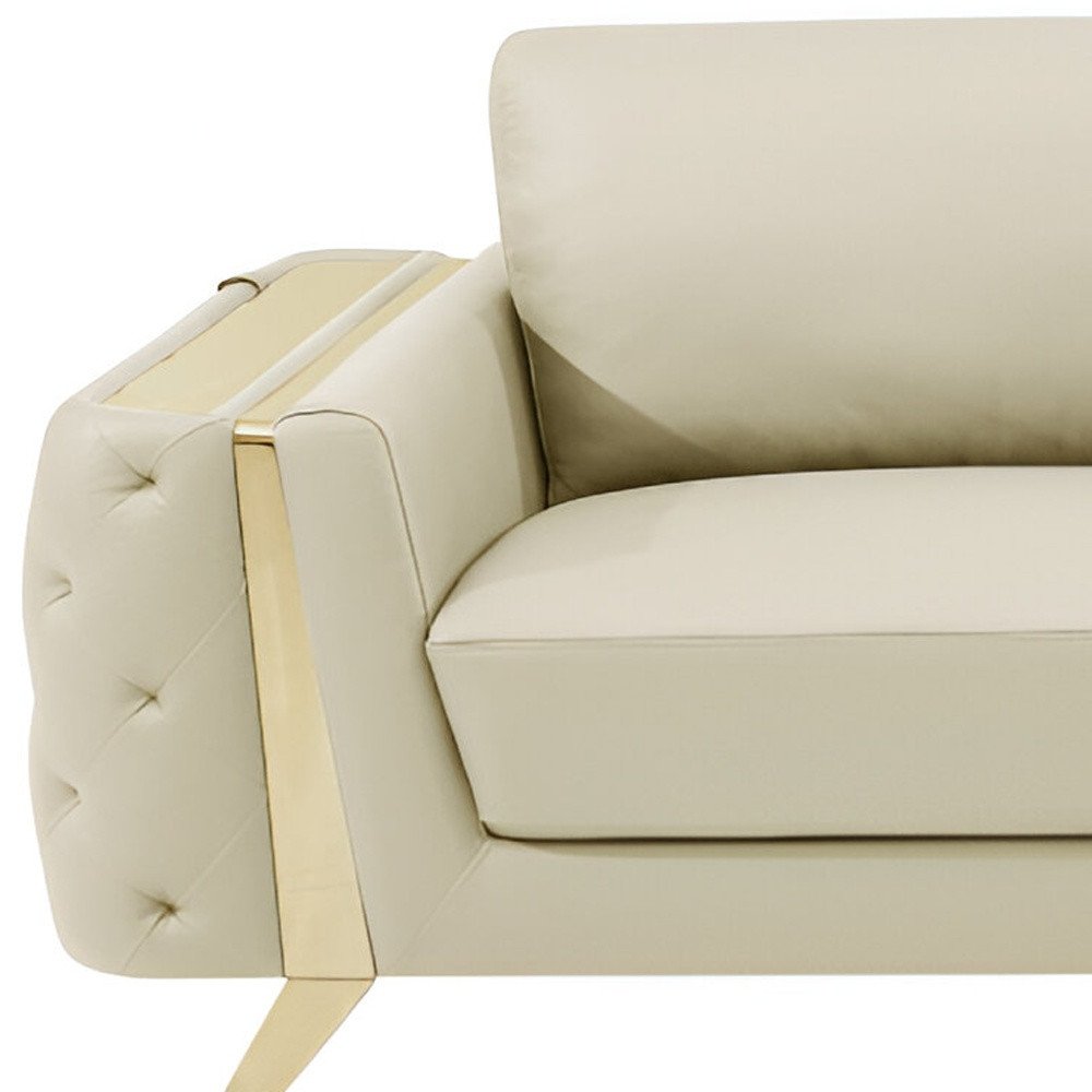Beige Italian leather sofa with gold legs, 90 inches long.