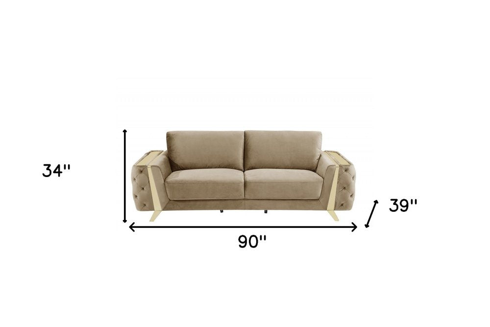 Beige velvet sofa with gold legs, 90 inches long.