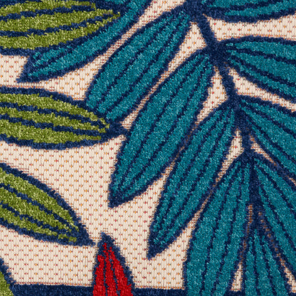 Teal blue and olive green embroidered leaves on beige woven fabric; textured botanical motif.