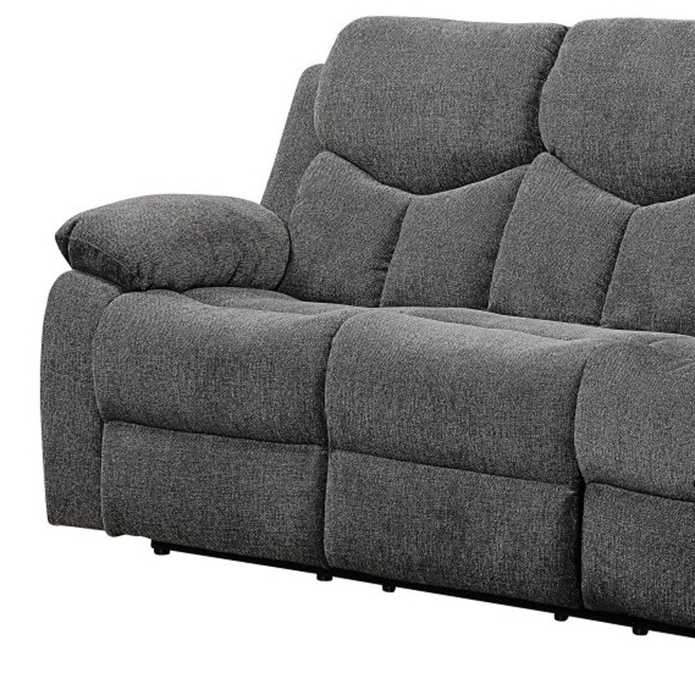 Charcoal gray textured fabric sectional sofa with oversized back cushions and padded armrest.