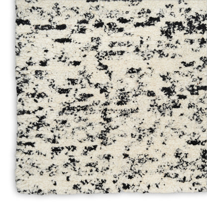 Cream speckled granite countertop with black flecks; natural stone for kitchen or bath surfaces.