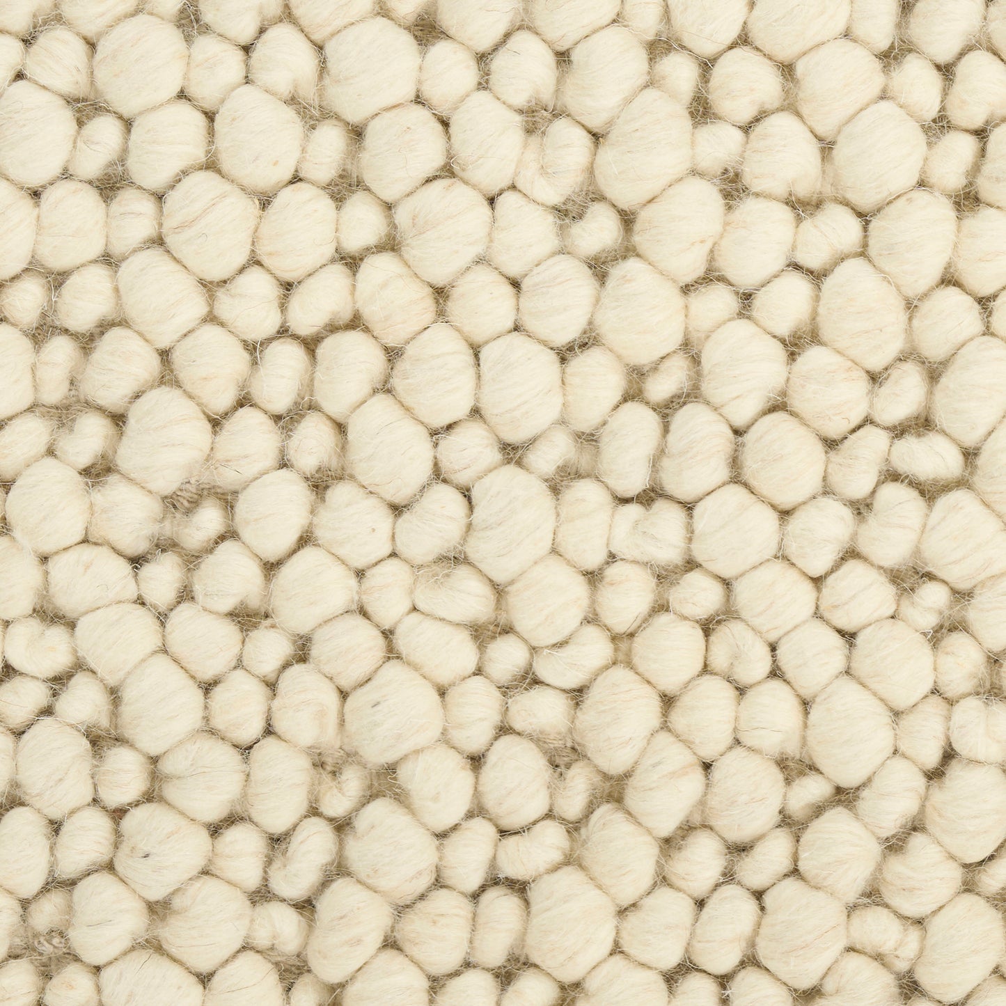 Cream boucle rug with dense, rounded wool tufts creating a soft, cozy textured surface.