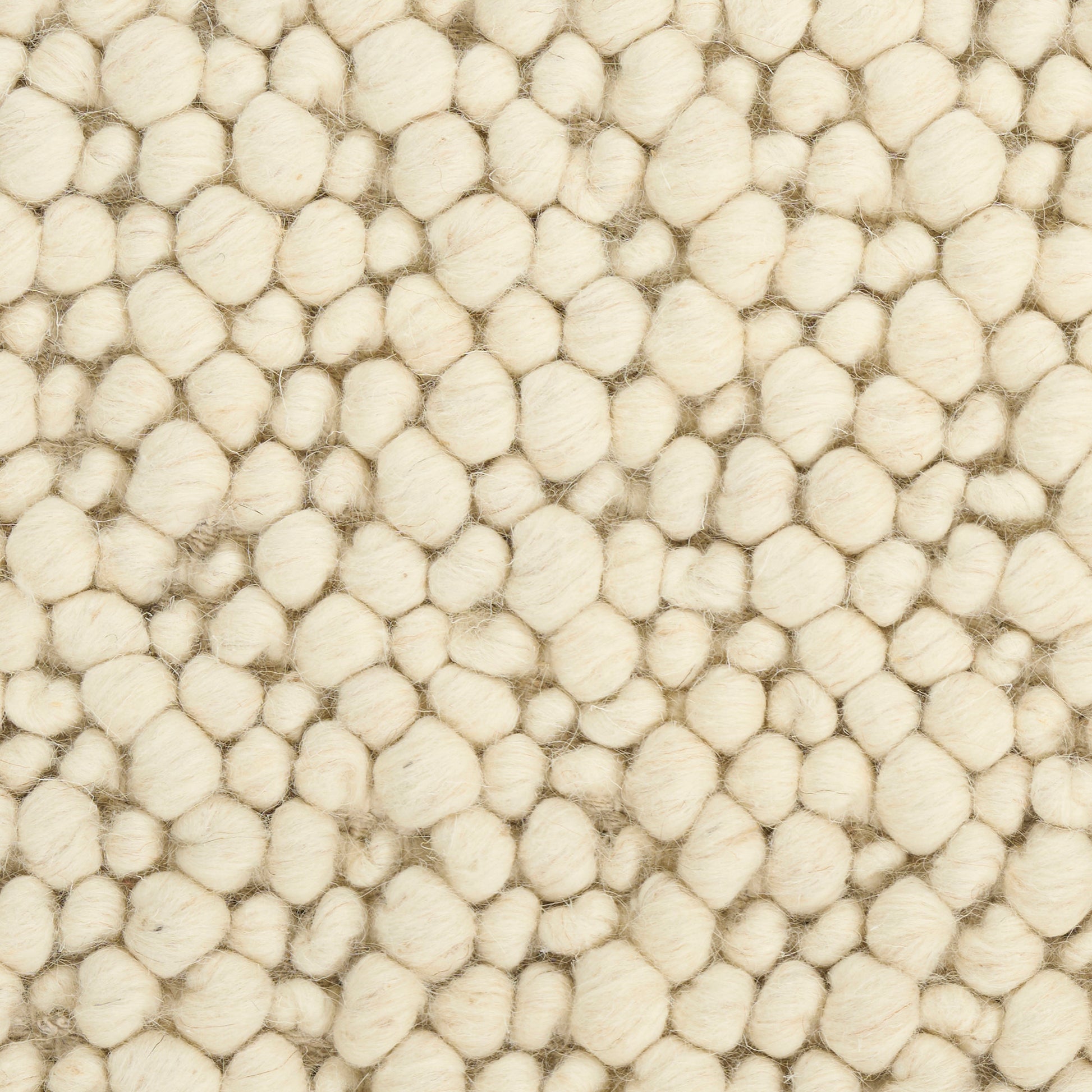 Cream boucle rug with dense, rounded wool tufts creating a soft, cozy textured surface.