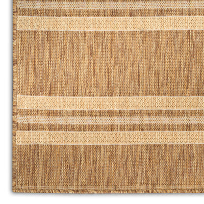 Natural jute rug with light and dark beige stripes, flatwoven with a fringed edge.