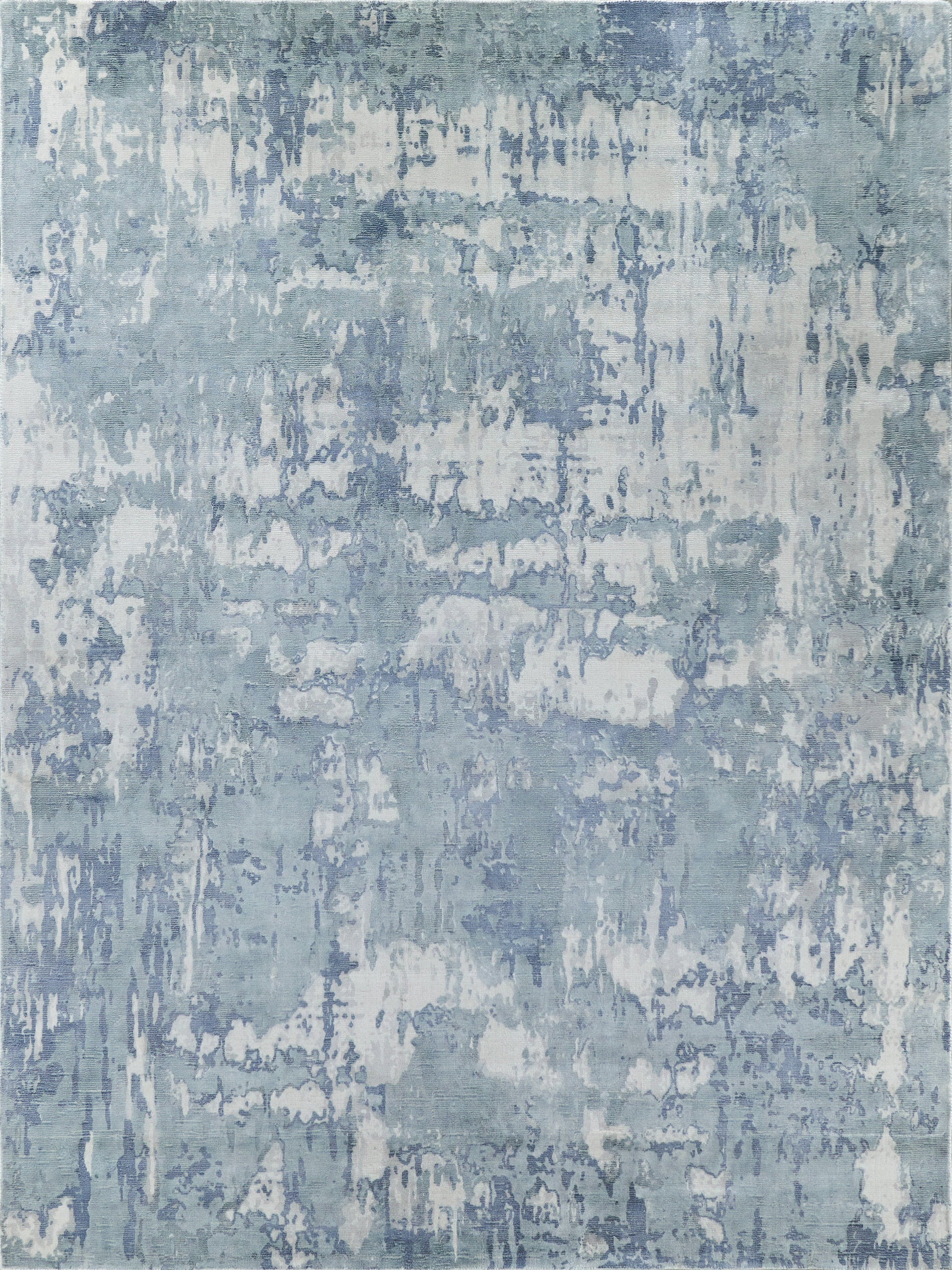 Blue-gray abstract distressed rug with whitewashed pattern for a modern coastal look.