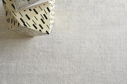 Beige plush indoor hand-knotted rug, 2' x 3'.
