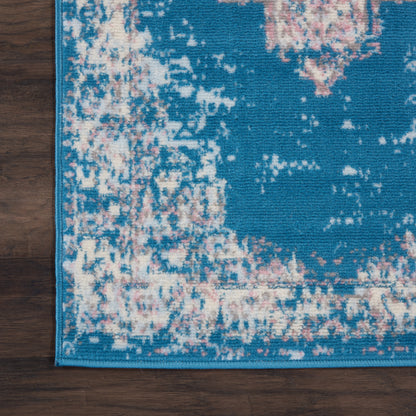 Teal blue distressed runner rug with pink and cream pattern, teal border, on dark wood floor