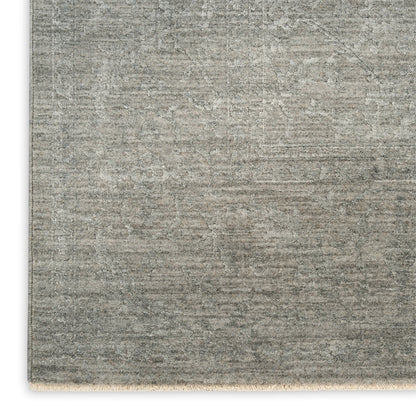 Rectangular gray distressed rug with a faded oriental pattern and short fringe along the bottom edge.