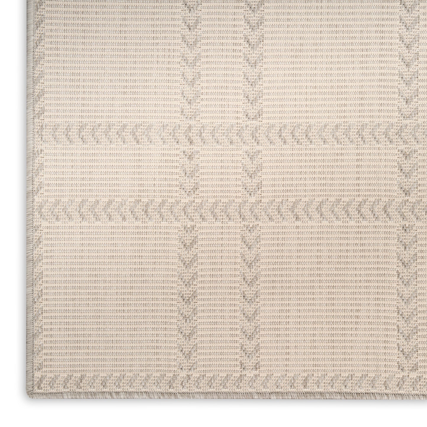 Beige woven area rug with block plaid and braided border; soft cotton-like texture for living rooms.