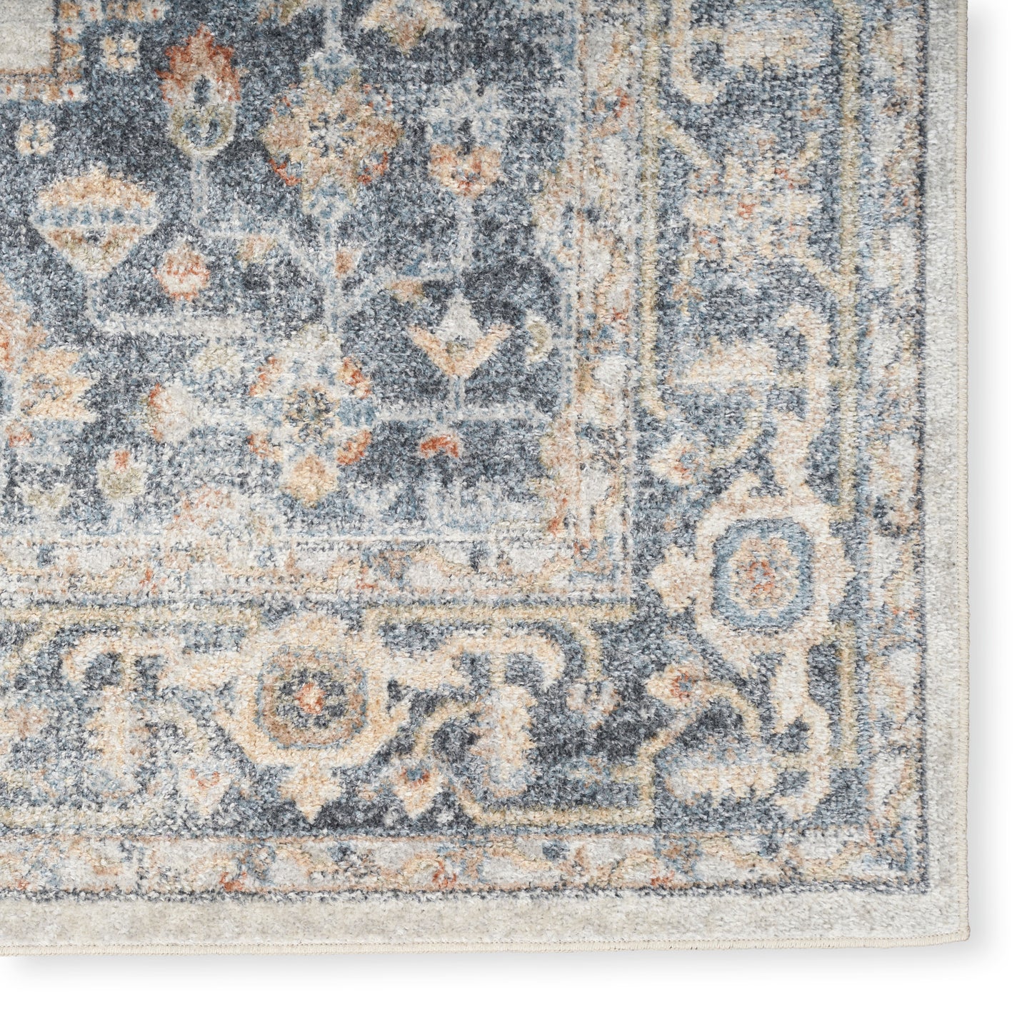 Distressed blue Persian-style area rug with ivory & peach floral medallion pattern; plush pile and beige edge binding.
