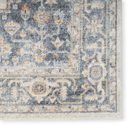 Distressed blue Persian-style area rug with ivory & peach floral medallion pattern; plush pile and beige edge binding.