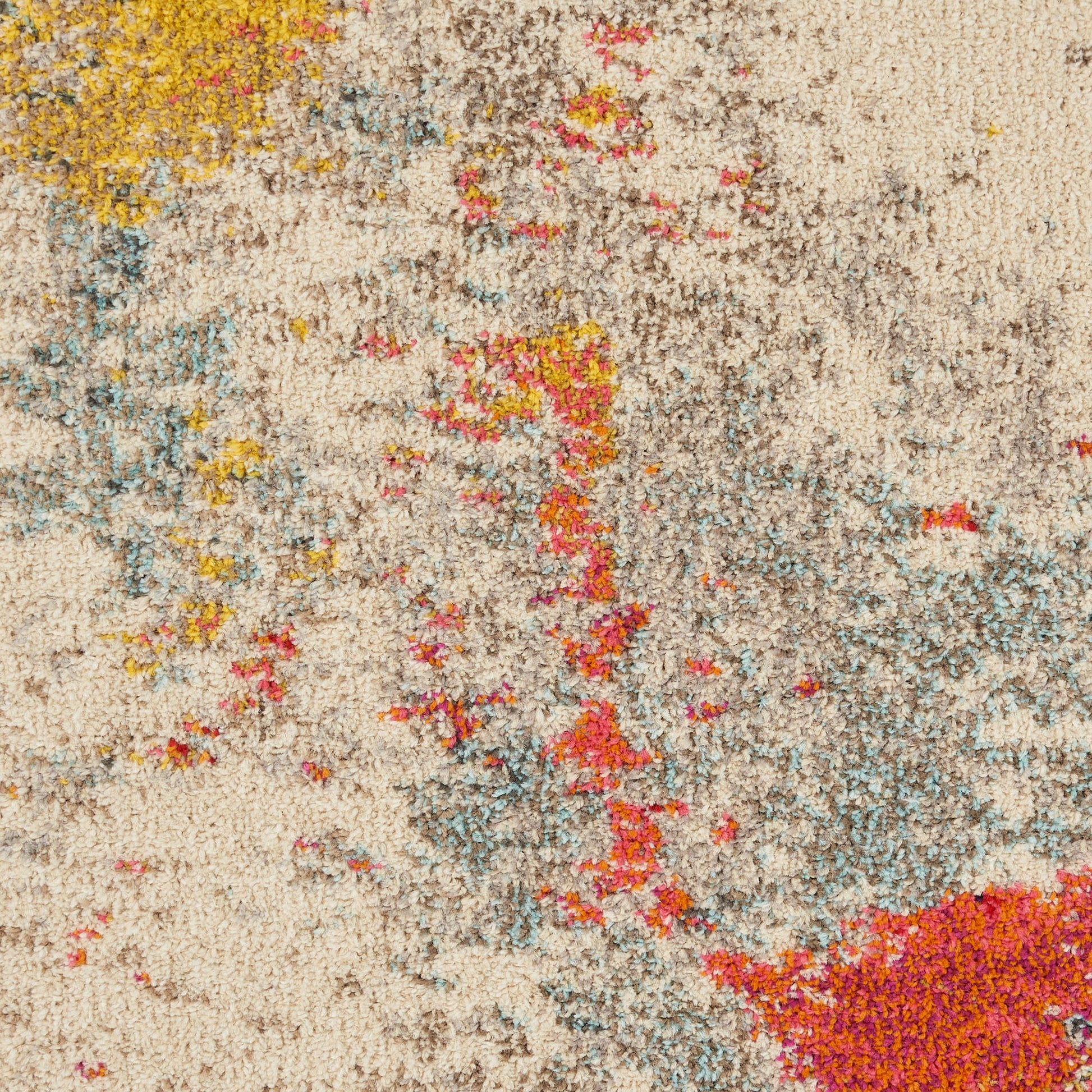 Abstract multicolor shag rug with beige base; splashes of yellow, pink, blue and red create an arty, textured look.