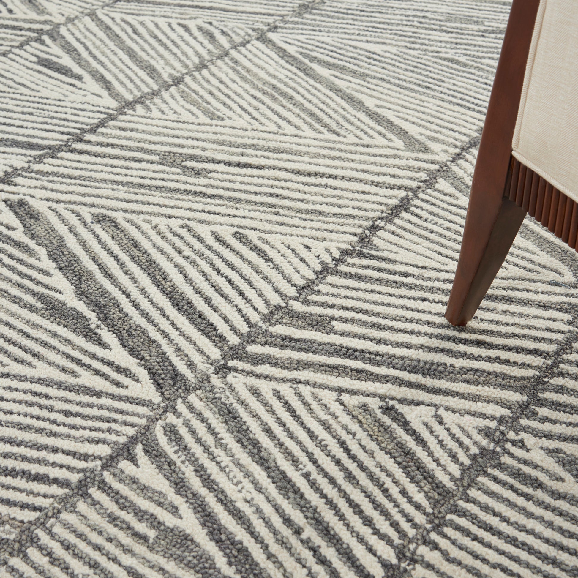 Ivory-gray geometric area rug with textured loop pile and bold linear stripes; modern floor decor.
