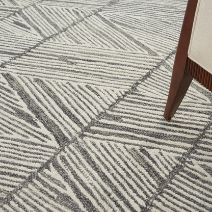 Ivory-gray geometric area rug with textured loop pile and bold linear stripes; modern floor decor.
