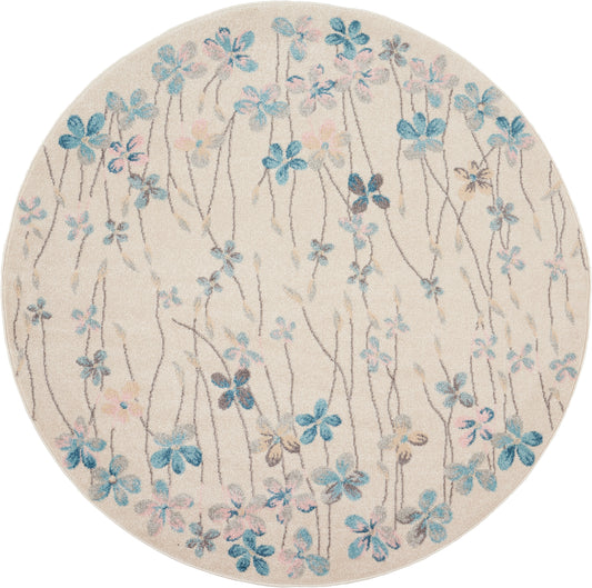 Round beige rug with blue floral vine pattern and subtle pink blossoms, soft decorative home accent.