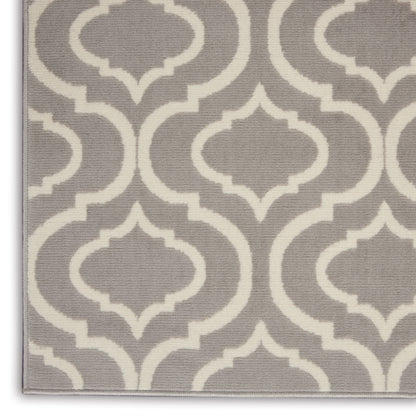 Gray rug featuring a white trellis geometric pattern, textured woven fabric, modern decorative style.