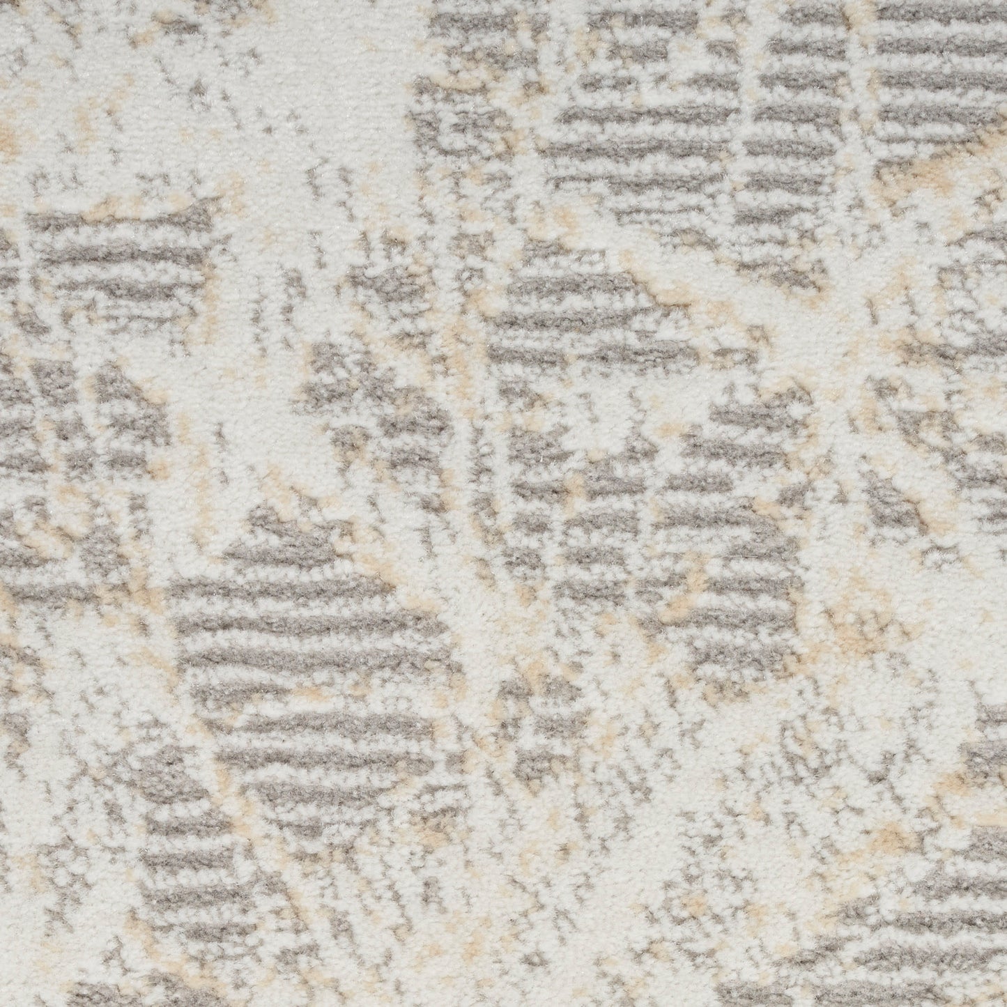 Cream textured rug with gray and beige abstract geometric pattern; soft plush pile.