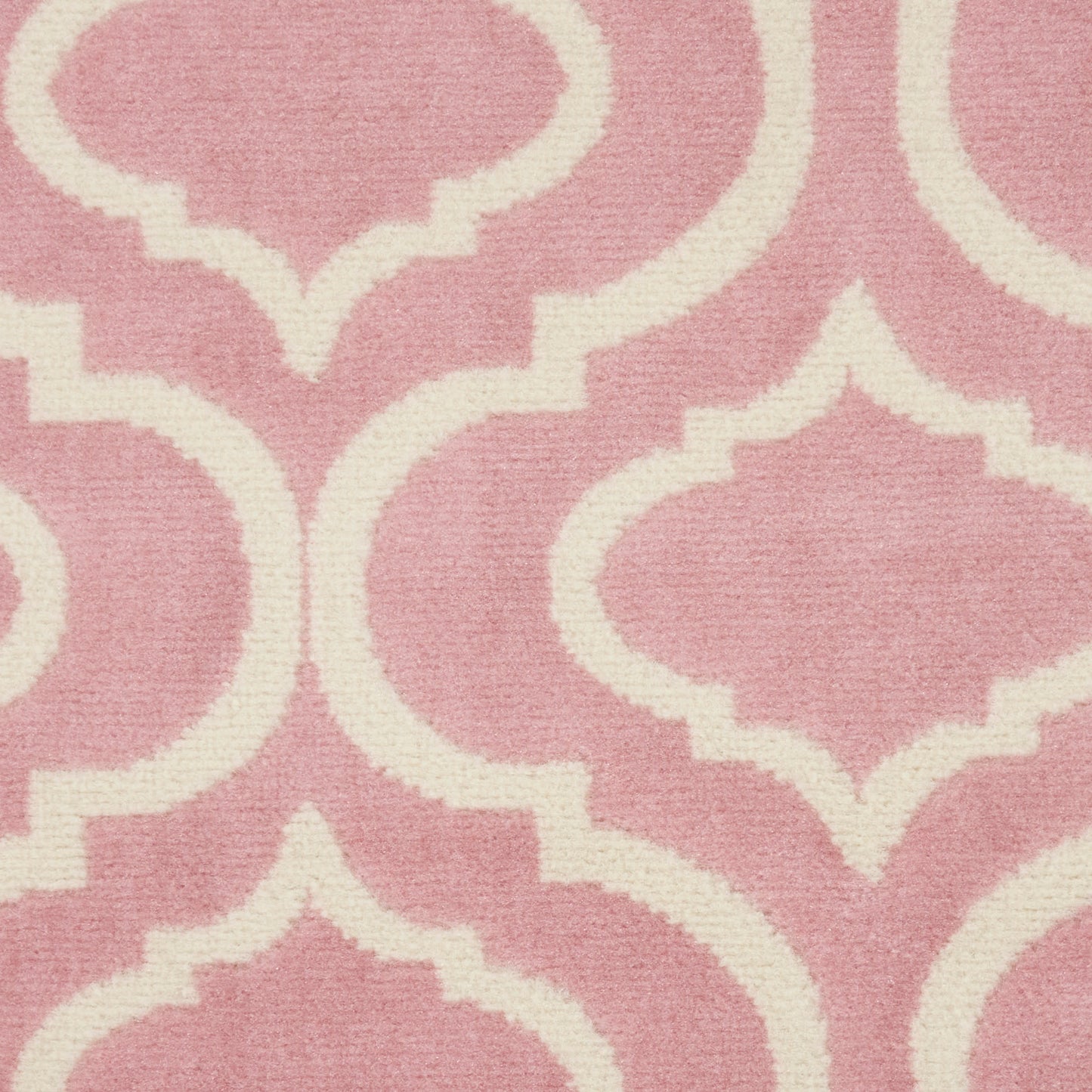 Pink mauve woven rug with white quatrefoil lattice pattern.