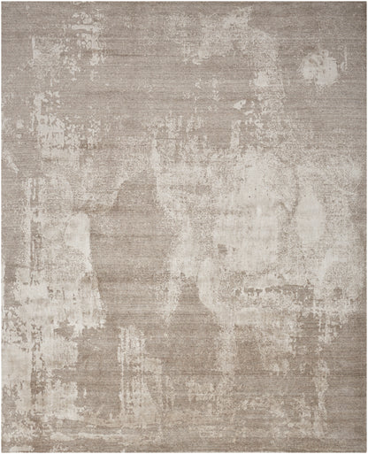 Rectangular beige-taupe rug featuring an abstract, distressed pattern and subtle textured finish.