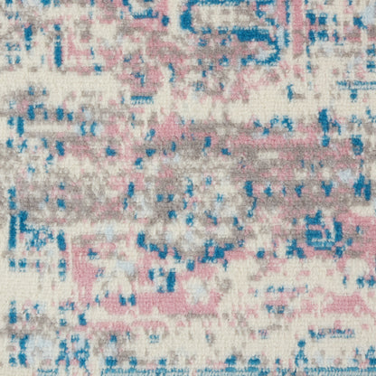 Soft, distressed abstract area rug with pink, blue, cream & gray tones.