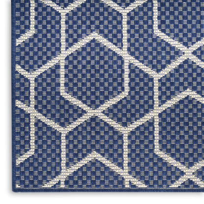 Navy blue woven rug with white geometric lattice diamonds, textured grid pattern, modern decorative floor mat.