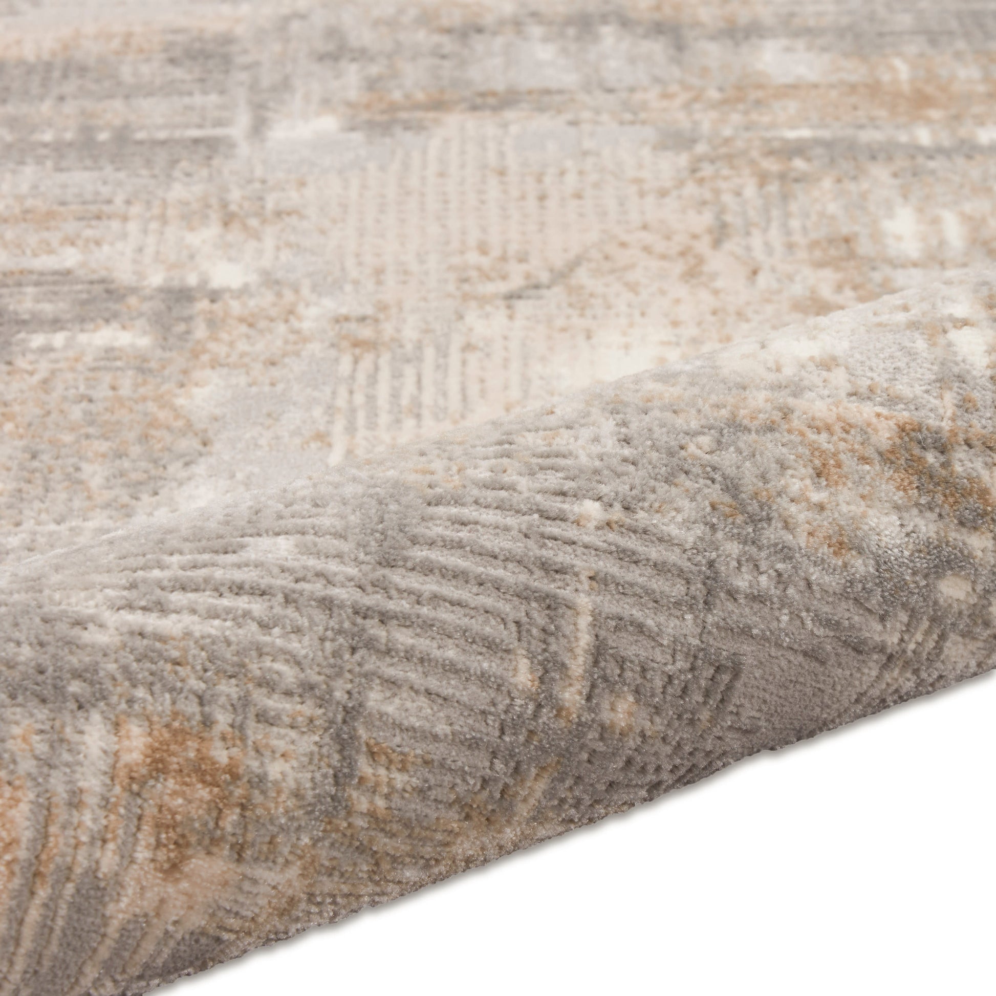 Close-up of a soft gray and beige patterned rug runner with abstract geometric texture and folded edge.