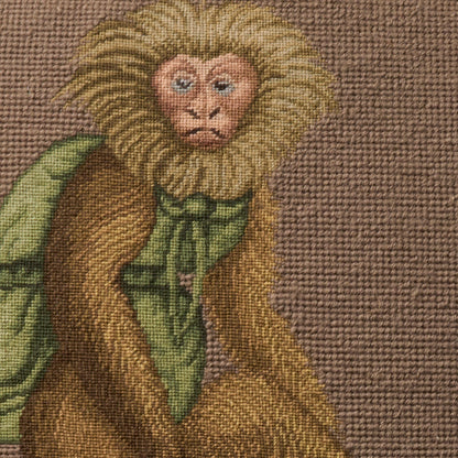 Woven rug featuring a heraldic lion motif in tan, gold, brown & green with a textured weave.