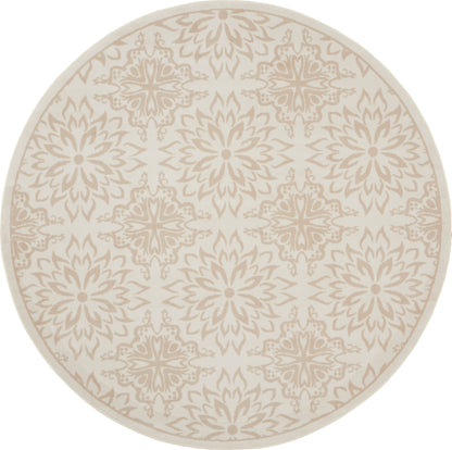 Round beige rug with taupe mandala floral motifs in a repeating pattern